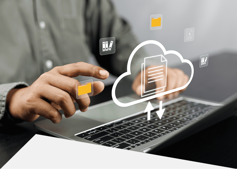 Hands using laptop with cloud icons.